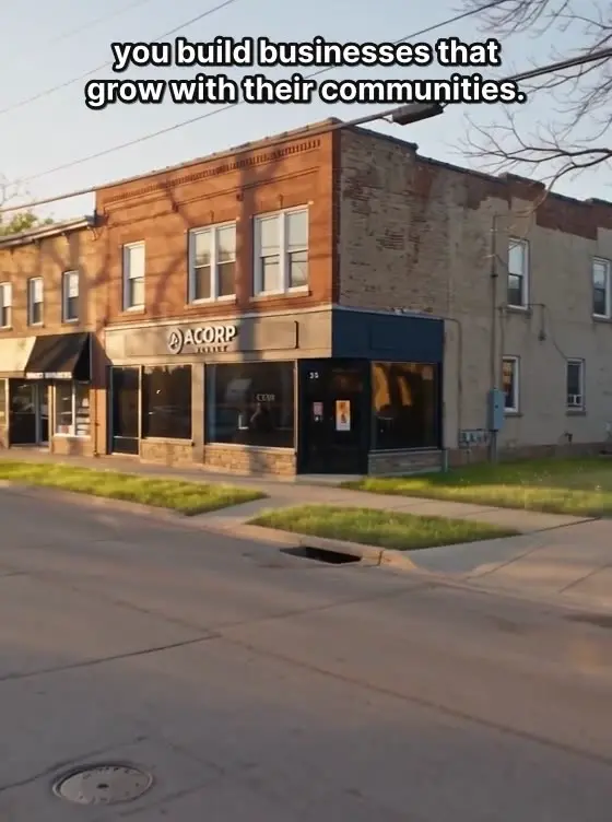 Golden-hour aerial of the ACORP neighborhood storefronts